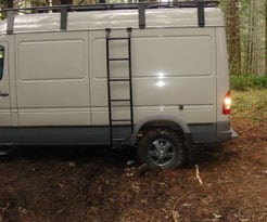 A Van is turning around in the forest - side