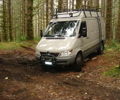 A Van is turning around in the forest - Front